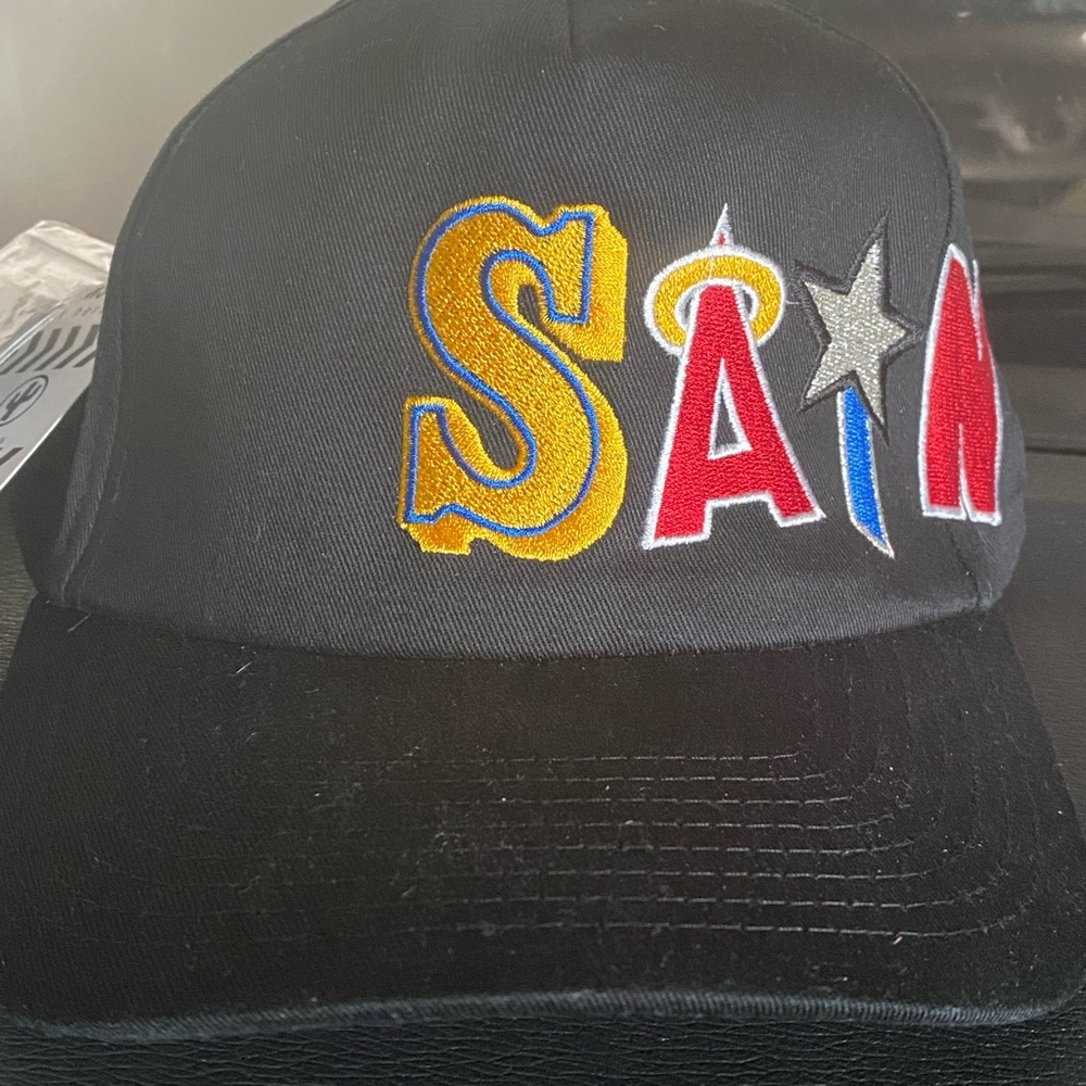 Adjustable Hat. Mainly black w/ red, blue, yellow
